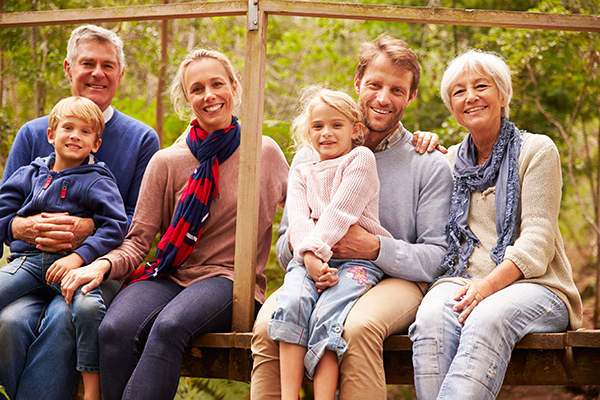 Multi-generation family portrait on a bridge in a forest